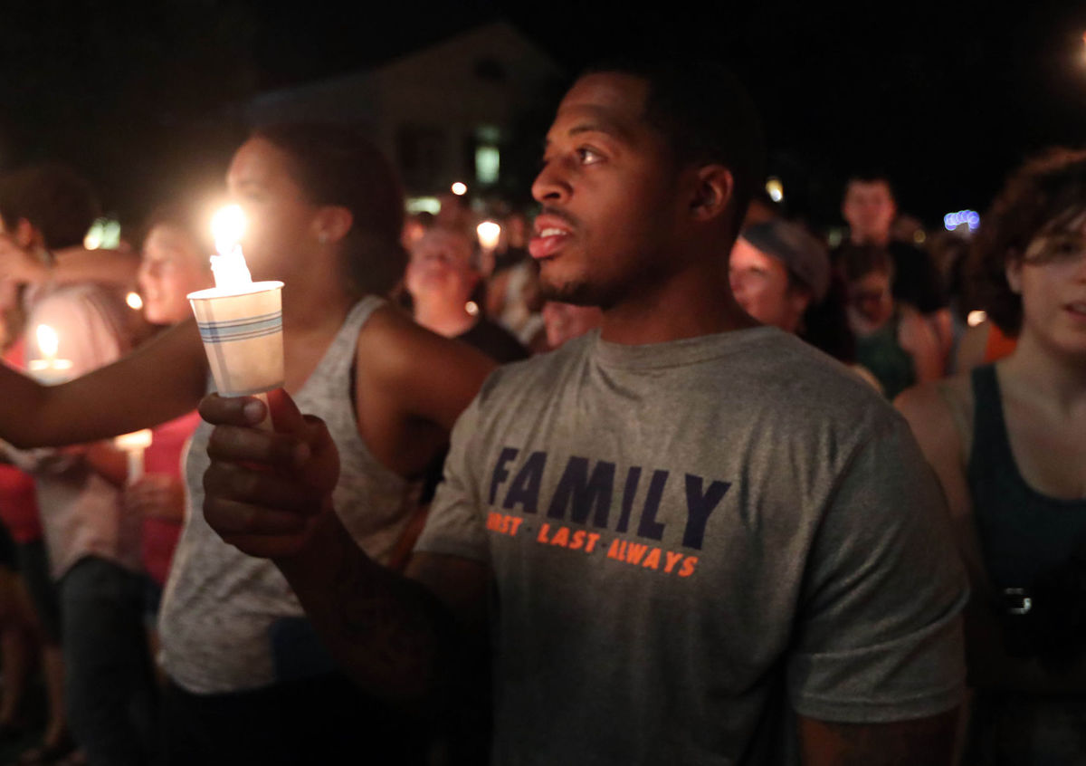 People hold a candle-light vigil on August 16, 2017 in Charlottesville