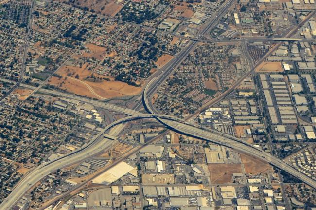 An aerial view of the city of Riverside centered around a highway interchange.